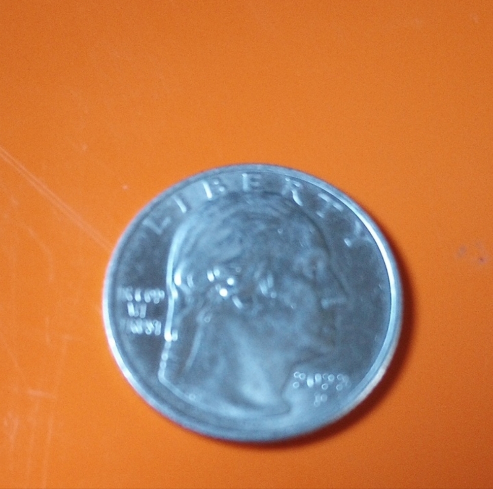 Silver Coin on Orange Background